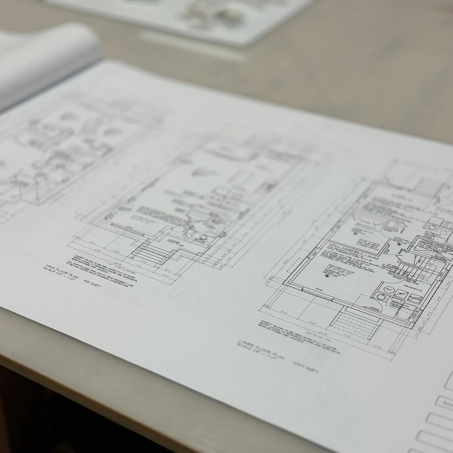 Architectural construction plans arranged on a design table